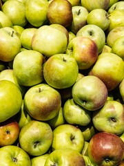 Fresh green apples piled together in a vibrant display at a local market during harvest season