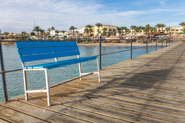 Blue bench inviting relaxation on a wooden pier in marsa alam, egypt