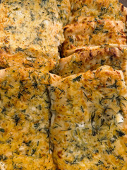 Homemade bread topped with herbs and spices, ready for enjoyment at a cozy gathering