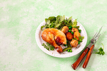 Spring lettuce leaves with new potatoes and baked chicken.