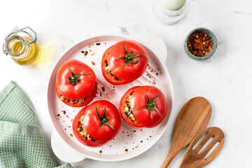 Turkey-stuffed tomatoes on a white background