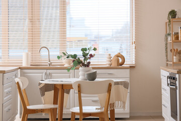 Interior of kitchen with dining table, counters and window