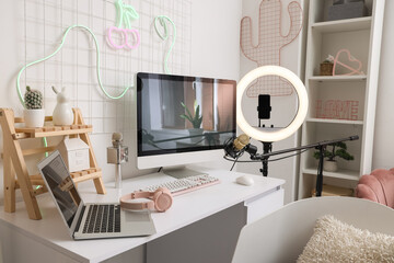 Blogger's workplace with computer and laptop in office