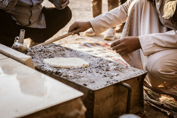 Traditional bread baking in egyptian desert setting