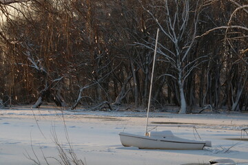 Boat in ice on winter lake