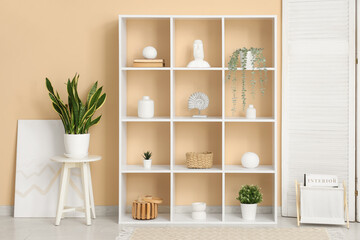 Interior of living room with white shelf unit and plants