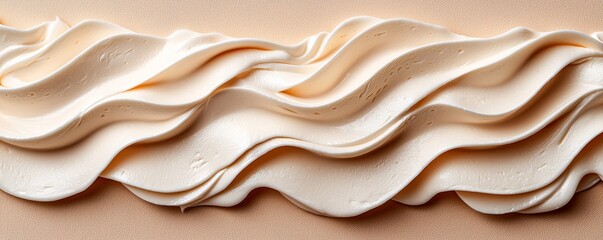 A smooth, creamy layer of whipped frosting with elegant, wavy textures, perfect for decorating cakes and desserts.