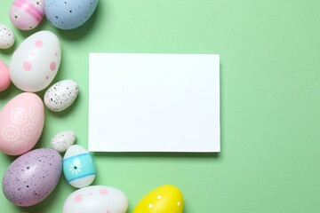 Happy Easter. Colorful eggs with paper card on color background, space for text or advertising