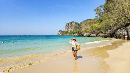 Exploring the pristine sands of Railay Beach in Krabi Thailand on a sunny day