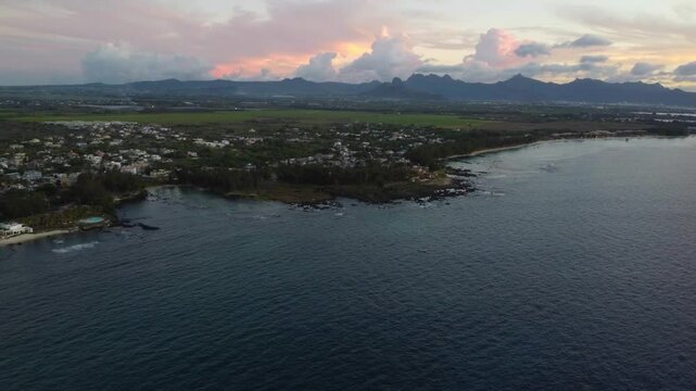 Aerial view in Mauritius over Pointe aux Piments beach and beautiful mountains in the Indian Ocean