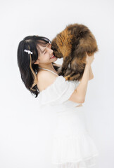 Portrait of Asian woman young pretty female beautiful standing holding her cat fluffy tortoiseshell cute kitten breed pussycat pet friend and smiling feeling love, isolated over white background.