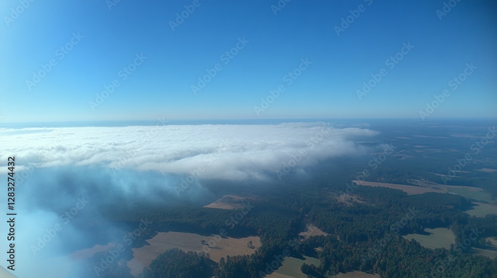 Poster gazing from above, a mesmerizing expanse of clouds blankets the earth, creating a dreamlike atmosphe