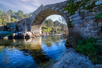 Historical roman bridge across the river Tietar