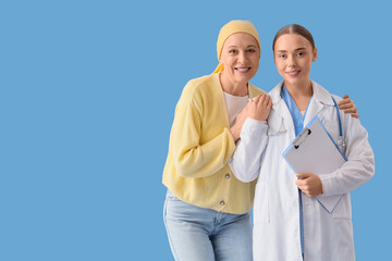 Mature woman after chemotherapy hugging doctor on blue background. Brain cancer concept