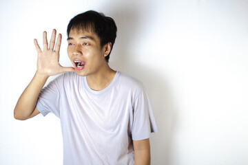 Asian teenager in white t-shirt is posing and screaming loudly