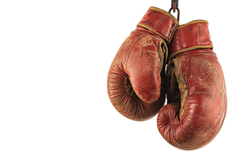 Old red boxing gloves hanging on a chain