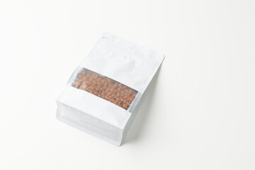 Packaging of Roasted Coffee Beans in a Clear Bag on White Background