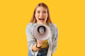 Young woman shouting into megaphone on yellow background