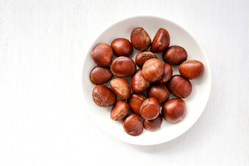 chestnut in white plate on white background