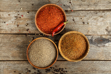 Bowls with aromatic spices on wooden background