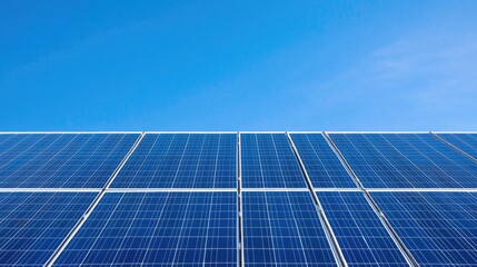 Obraz premium Solar panels under a clear blue sky, renewable energy