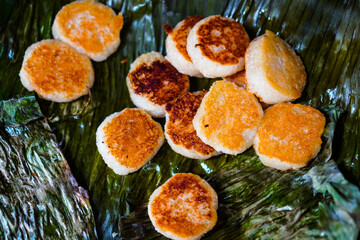 A seller grills bakpia on hot charcoal. Bakpia is one of Indonesian traditional food. Delicious Bakpia at Ngasem market (traditional market) in Yogyakarta, Indonesia.