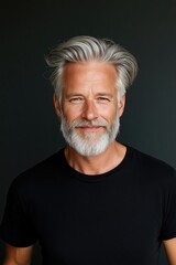 Obraz premium Portrait of a Confident Mature Man with Gray Hair and Beard in Black T-Shirt