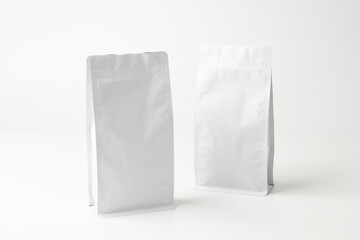 Two Plain White Packaging Bags on a Light Surface for Product Display or Photography