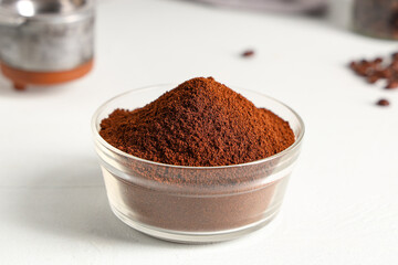 Bowl of coffee powder on white background