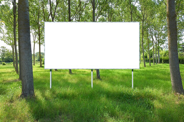 Blank advertising signboard in a countryside with trees - rural scene concept with space for inserting text