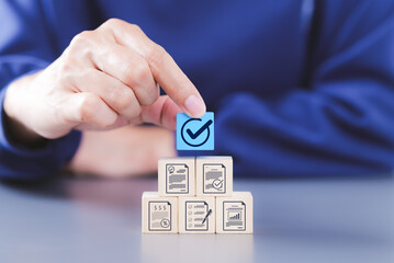 Document review process and quality control concept. Hand placing checkmark. wooden blocks document icons, certified, document verification, business approval process, certificate management, audit,