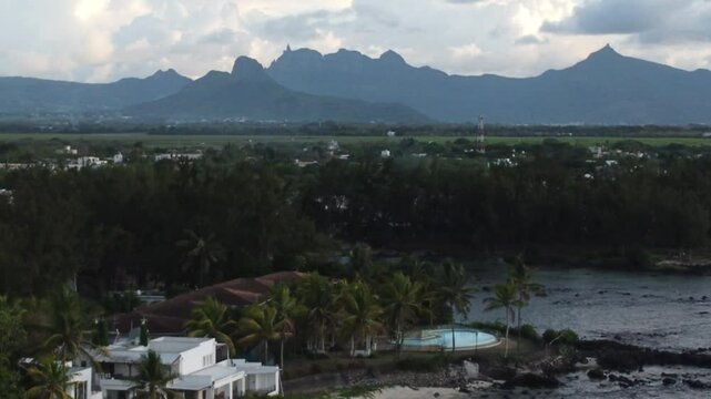 Aerial view in Mauritius over Pointe aux Piments beach and beautiful mountains in the Indian Ocean