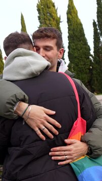 Romantic moments between a young caucasian gay couple, hugging and kissing in various outdoor locations