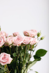 Close-up, bouquet of small pink roses on a white background.