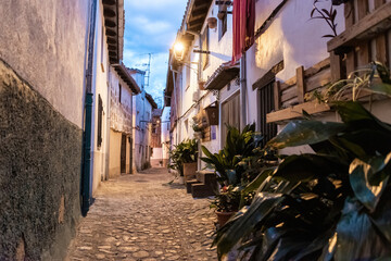 Beautiful nightfall view of a typical and narrow street in the Jewish Quarter of Hervás at night,  one of the best preserved in Spain, an Ambroz Valley village at Caceres, Extremadura, Spain. 