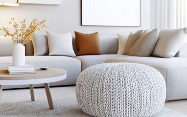 Obraz premium Living room, close up view, featuring a plush light gray sectional and an oversized, intricately knitted pouf replacing the coffee table, warm ambient