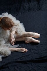 Young beautiful ballerina is posing in studio