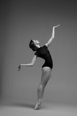 Young beautiful ballerina is posing in studio