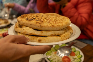 Freshly prepared naan bread served on a plate.