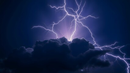 A powerful lightning display illuminates dark clouds in the night sky, capturing the dramatic and electrifying essence of a thunderstorm.  