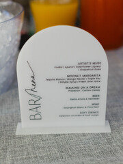 Fototapeta premium Unique bar menu showcasing creative cocktails at a stylish event during daylight hours