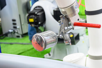 Close up scene the automatic painting robot working with automotive parts.