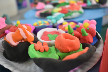 Colorful clay art creations displayed on table, showcasing vibrant and imaginative designs
