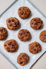 Chocolate cookies dough on a baking tray ready to be baked. Homemade baking.