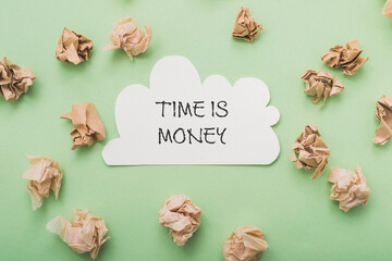 White piece of paper with the words time is money written on it