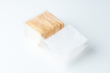 Sliced Bread Packaged in a Clear Plastic Container on a Plain Background