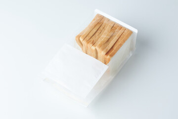 Sliced Bread Packaged Neatly in a Clear Plastic Wrapper on a Light Background
