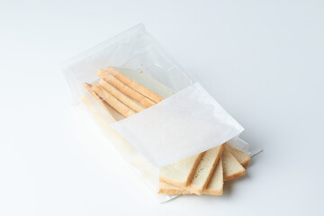 Sliced Bread Sticks and Crackers Arranged in a Simple Package on a Clean Surface
