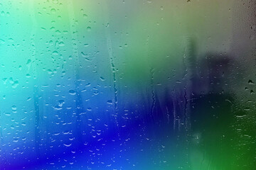 Abstract colorful background with raindrops on a wet window