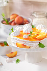 Tasty peach meringue with fruits and powdered sugar.